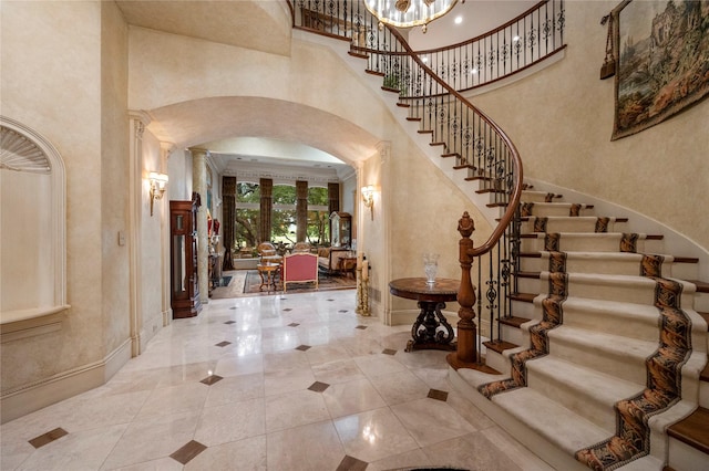 1524 Eastwick Ln, Plano, TX 75093 - entrance foyer featuring arched walkways, a high ceiling, stairway, baseboards, and tile patterned floors