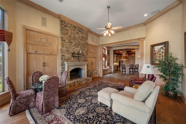 1524 Eastwick Ln, Plano, TX 75093 - living room featuring wood finished floors, a ceiling fan, ornamental molding, a fireplace, and baseboards