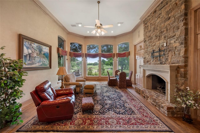 1524 Eastwick Ln, Plano, TX 75093 - living room with wood finished floors, a ceiling fan, ornamental molding, a stone fireplace, and a high ceiling
