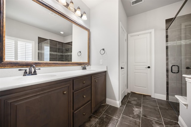 310 Hawthorn Dr, Wylie, TX 75098 - full bathroom featuring a shower stall, double vanity, and baseboards