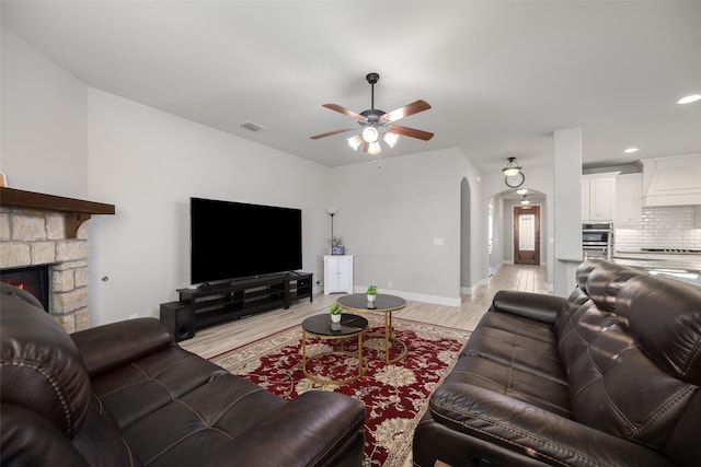 310 Hawthorn Dr, Wylie, TX 75098 - living room with arched walkways, a ceiling fan, light wood finished floors, baseboards, and recessed lighting