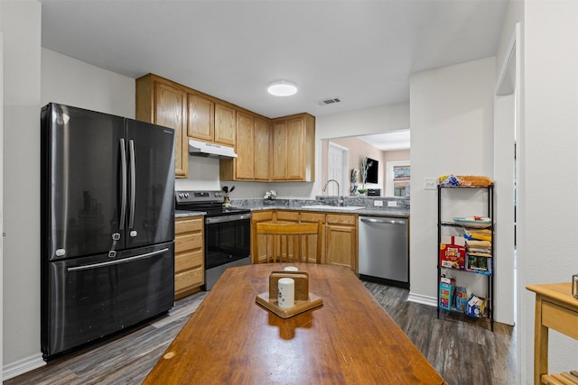3328 Royal Crest Dr, Fort Worth, TX 76140 - kitchen with stainless steel appliances, a sink, under cabinet range hood, dark wood finished floors, and wooden counters