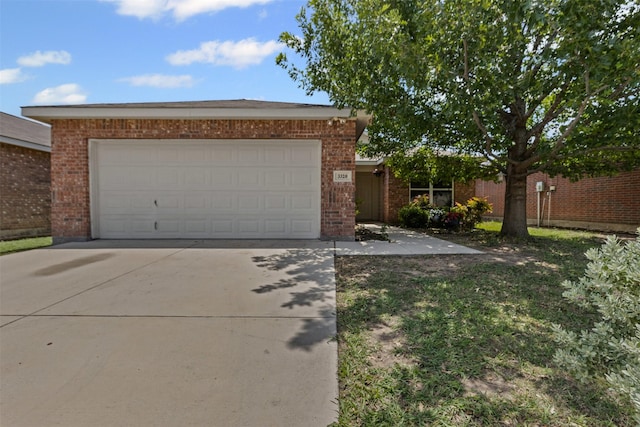3328 Royal Crest Dr, Fort Worth, TX 76140 - view of front of house with concrete driveway, brick siding, and a garage