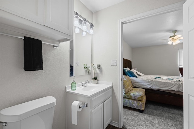 3328 Royal Crest Dr, Fort Worth, TX 76140 - half bathroom featuring connected bathroom, toilet, vanity, and ceiling fan