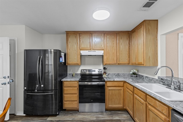 3328 Royal Crest Dr, Fort Worth, TX 76140 - kitchen with appliances with stainless steel finishes, under cabinet range hood, a sink, and dark wood finished floors