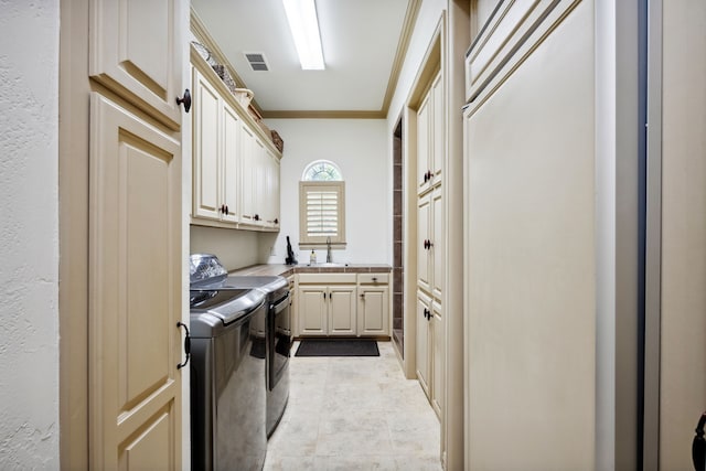 508 Moraine Way, Heath, TX 75032 - laundry room featuring independent washer and dryer, ornamental molding, and cabinet space