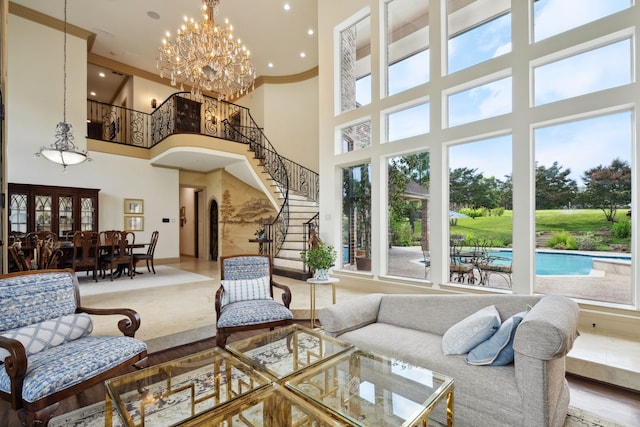 508 Moraine Way, Heath, TX 75032 - living room featuring a towering ceiling, stairway, a chandelier, crown molding, and recessed lighting