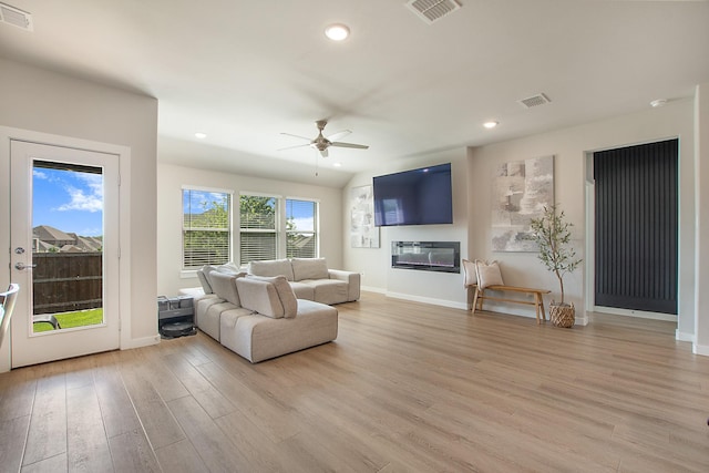 4007 Buckeye Bnd, Melissa, TX 75454 - living room with a ceiling fan, light wood-type flooring, baseboards, recessed lighting, and a glass covered fireplace