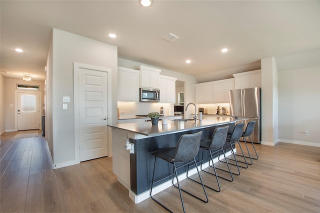 4007 Buckeye Bnd, Melissa, TX 75454 - kitchen with stainless steel appliances, light wood finished floors, baseboards, and recessed lighting