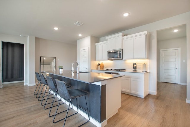 4007 Buckeye Bnd, Melissa, TX 75454 - kitchen with stainless steel appliances, a sink, light wood-type flooring, and recessed lighting