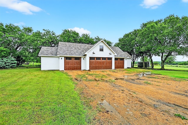 4920 County Road 179, Celina, TX 75009 - view of front of home with an outbuilding, a front lawn, a detached garage, and a shingled roof