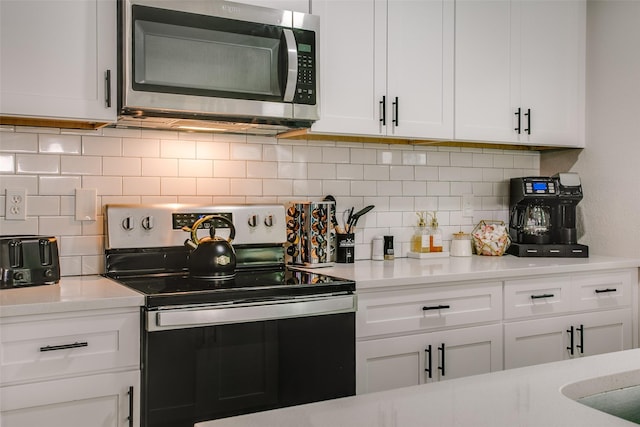 2110 Montana Trl, Grand Prairie, TX 76001 - kitchen featuring stainless steel appliances, white cabinetry, decorative backsplash, and light countertops