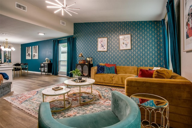 2110 Montana Trl, Grand Prairie, TX 76001 - living room featuring a chandelier, wallpapered walls, an accent wall, and wood finished floors