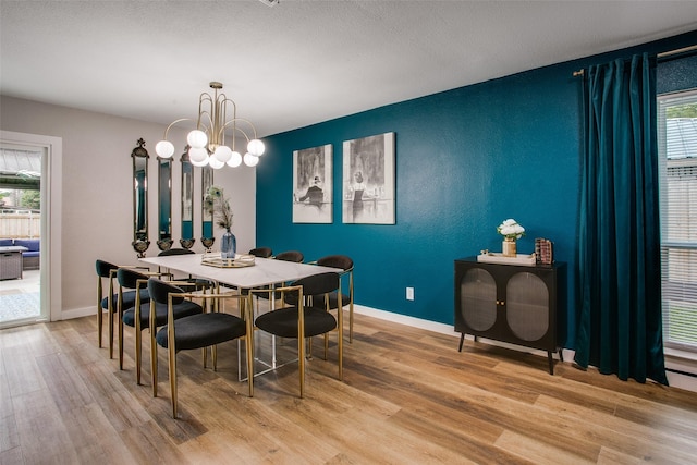 2110 Montana Trl, Grand Prairie, TX 76001 - dining area featuring wood finished floors, plenty of natural light, an accent wall, and baseboards