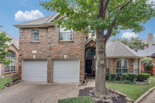 14592 Evergreen Ct, Addison, TX 75001 - view of front of property with driveway, an attached garage, a shingled roof, and brick siding