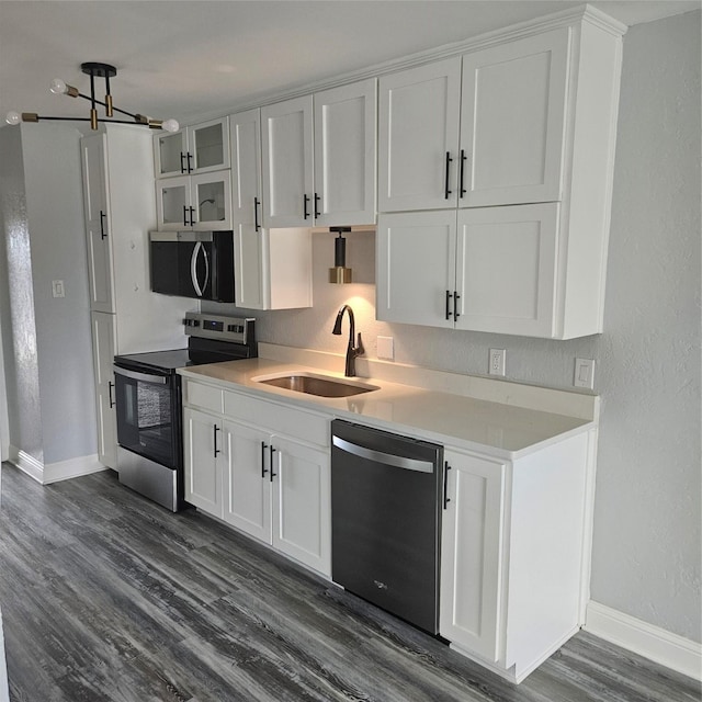 91 Runaway Bay Dr Unit 232, Runaway Bay, TX 76426 - kitchen featuring appliances with stainless steel finishes, a sink, dark wood-type flooring, and white cabinets