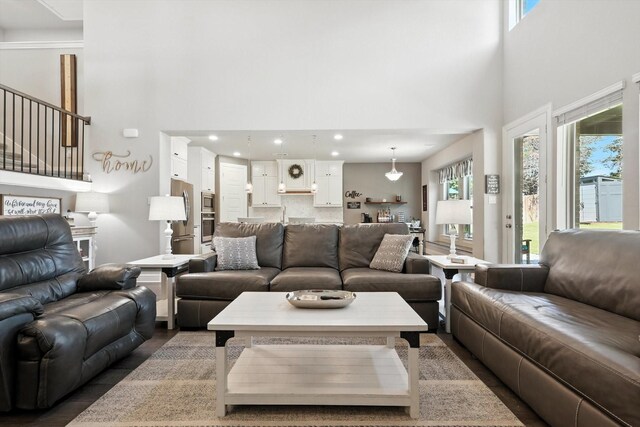 7431 Bald Cypress Dr, Ovilla, TX 75154 - living room with a chandelier, stairway, a towering ceiling, dark wood-style flooring, and recessed lighting
