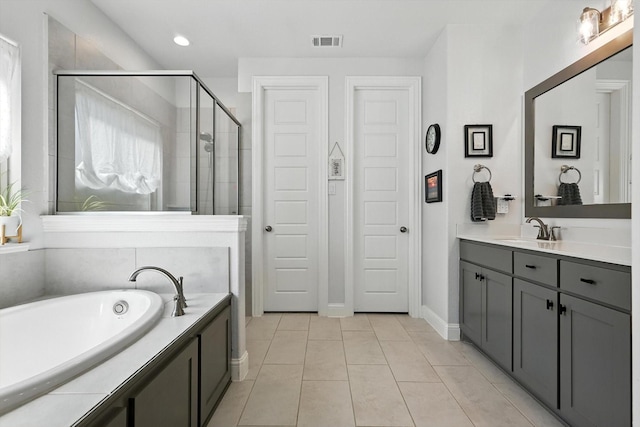 7431 Bald Cypress Dr, Ovilla, TX 75154 - bathroom with vanity, a bath, a shower stall, tile patterned floors, and recessed lighting