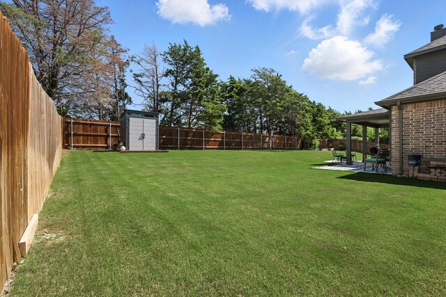 7431 Bald Cypress Dr, Ovilla, TX 75154 - fenced backyard featuring a patio and a storage unit