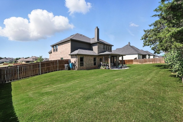 7431 Bald Cypress Dr, Ovilla, TX 75154 - back of house featuring a patio, brick siding, a chimney, a fenced backyard, and a shingled roof