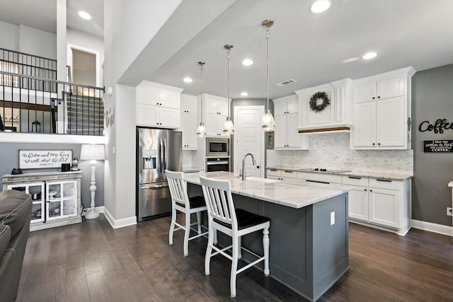 7431 Bald Cypress Dr, Ovilla, TX 75154 - kitchen featuring appliances with stainless steel finishes, white cabinets, dark wood finished floors, and recessed lighting