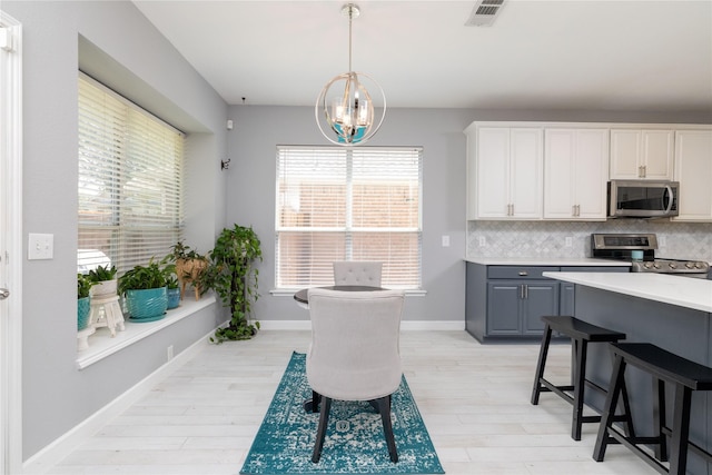 4405 Vista Meadows Dr, Fort Worth, TX 76244 - dining space featuring light wood-style floors, healthy amount of natural light, and a chandelier