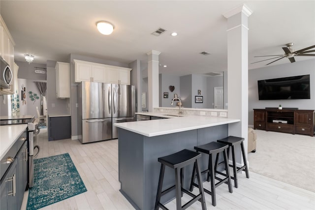 4405 Vista Meadows Dr, Fort Worth, TX 76244 - kitchen featuring appliances with stainless steel finishes, decorative columns, open floor plan, light countertops, and a sink