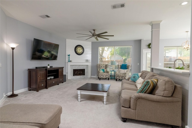 4405 Vista Meadows Dr, Fort Worth, TX 76244 - living room with a ceiling fan, light colored carpet, a chandelier, a fireplace, and baseboards