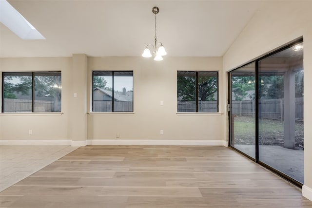 3301 Cliffview Dr, Corinth, TX 76210 - spare room featuring light wood-style flooring, a chandelier, vaulted ceiling, and baseboards