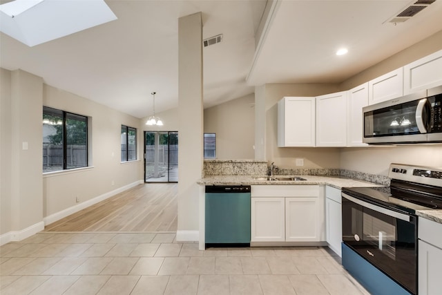 3301 Cliffview Dr, Corinth, TX 76210 - kitchen with stainless steel appliances, light stone countertops, white cabinetry, recessed lighting, and vaulted ceiling