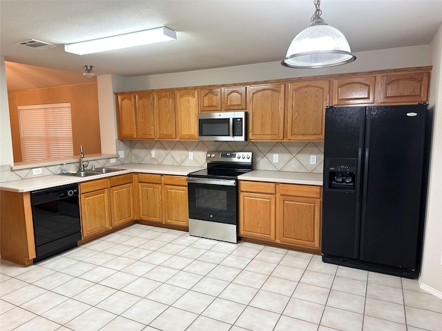 9404 Mirror Fountain Cir, Frisco, TX 75033 - kitchen featuring black appliances, light countertops, a sink, tasteful backsplash, and decorative light fixtures