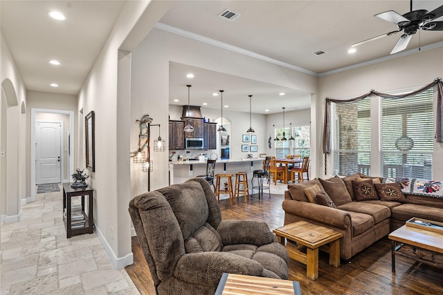 5100 Swisher Rd, Denton, TX 76208 - living area with ornamental molding, recessed lighting, arched walkways, a ceiling fan, and baseboards