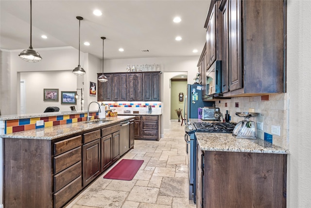 5100 Swisher Rd, Denton, TX 76208 - kitchen with appliances with stainless steel finishes, stone tile flooring, a sink, tasteful backsplash, and dark brown cabinets