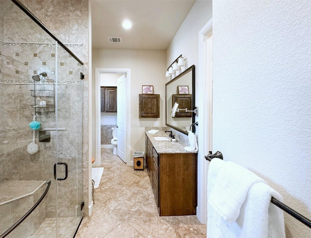 5100 Swisher Rd, Denton, TX 76208 - bathroom with toilet, vanity, a shower stall, and tile patterned floors