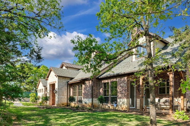 5100 Swisher Rd, Denton, TX 76208 - view of front of property featuring brick siding, a front yard, roof with shingles, and a chimney