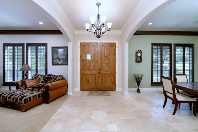 5100 Swisher Rd, Denton, TX 76208 - entryway featuring arched walkways, a chandelier, crown molding, healthy amount of natural light, and baseboards