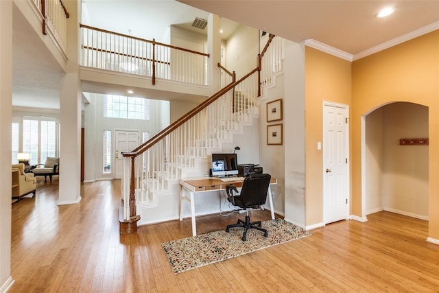 3704 Roxbury Ln, Plano, TX 75025 - office area with a high ceiling, arched walkways, wood-type flooring, and crown molding