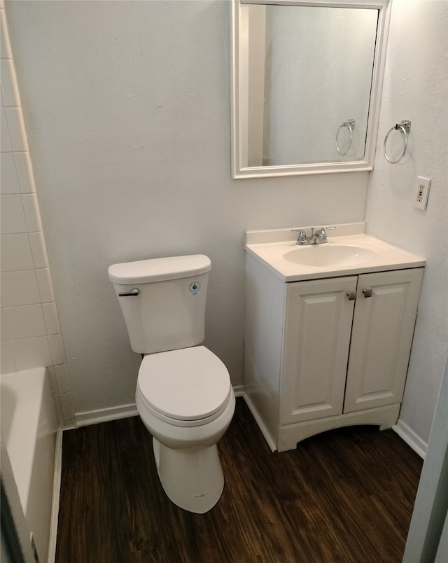 4214 Mehalia Dr, Dallas, TX 75241 - bathroom featuring wood finished floors, vanity, toilet, and baseboards