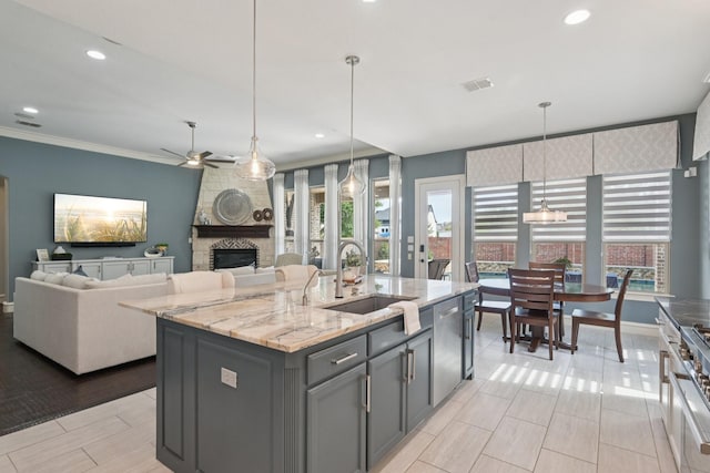 4158 Benchmark Ln, Frisco, TX 75034 - kitchen featuring a sink, a fireplace, healthy amount of natural light, a ceiling fan, and recessed lighting