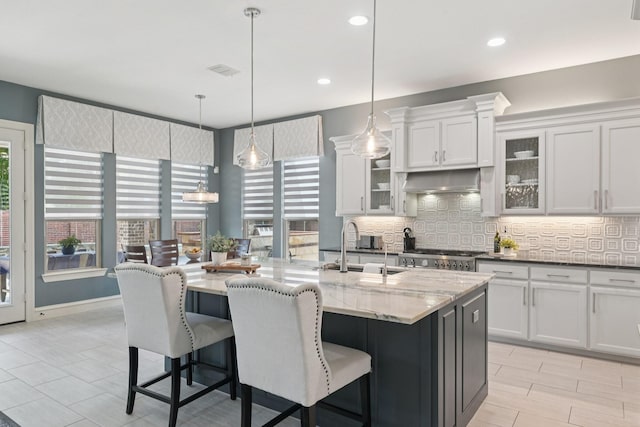 4158 Benchmark Ln, Frisco, TX 75034 - kitchen with a sink, backsplash, healthy amount of natural light, a breakfast bar area, and recessed lighting