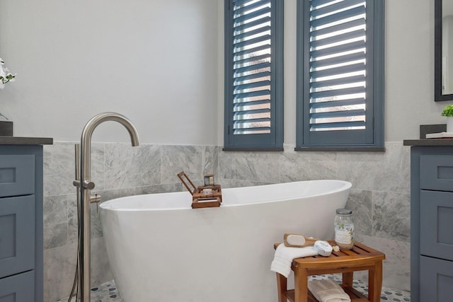 4158 Benchmark Ln, Frisco, TX 75034 - full bathroom featuring tile walls, vanity, a soaking tub, and wainscoting