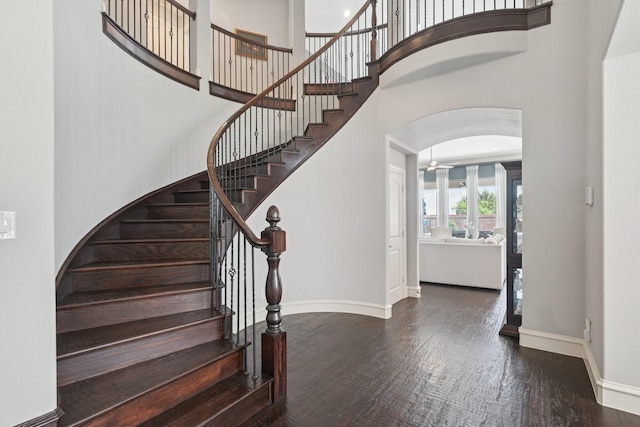 4158 Benchmark Ln, Frisco, TX 75034 - foyer entrance with a high ceiling, baseboards, wood finished floors, arched walkways, and stairs
