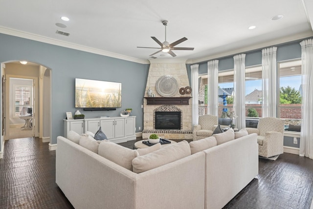 4158 Benchmark Ln, Frisco, TX 75034 - living room featuring arched walkways, baseboards, a ceiling fan, crown molding, and a fireplace