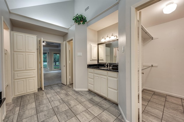 2308 Aberdeen Bnd, Carrollton, TX 75007 - bathroom featuring vanity, tile patterned flooring, and a spacious closet