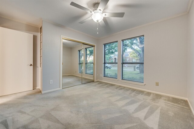 2308 Aberdeen Bnd, Carrollton, TX 75007 - unfurnished bedroom featuring ornamental molding, carpet, a ceiling fan, and a closet