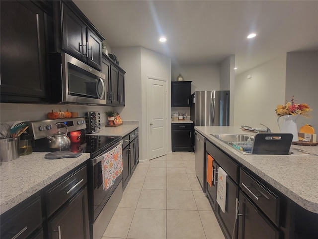 3400 Quiet Valley Rd, Fort Worth, TX 76123 - kitchen with appliances with stainless steel finishes, dark cabinets, light tile patterned floors, light countertops, and recessed lighting