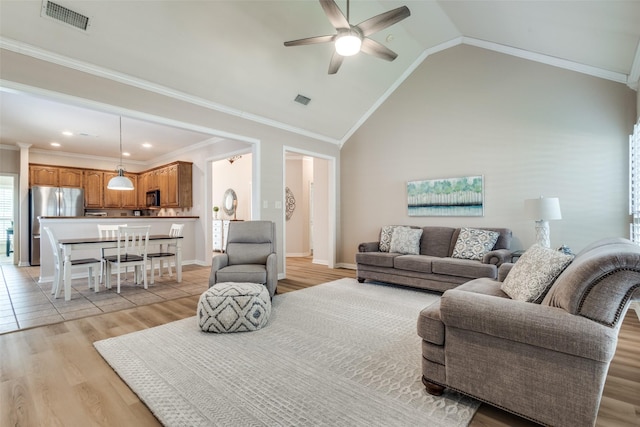 1908 Thompson Ct, Flower Mound, TX 75028 - living area with light wood-type flooring, a ceiling fan, lofted ceiling, and ornamental molding