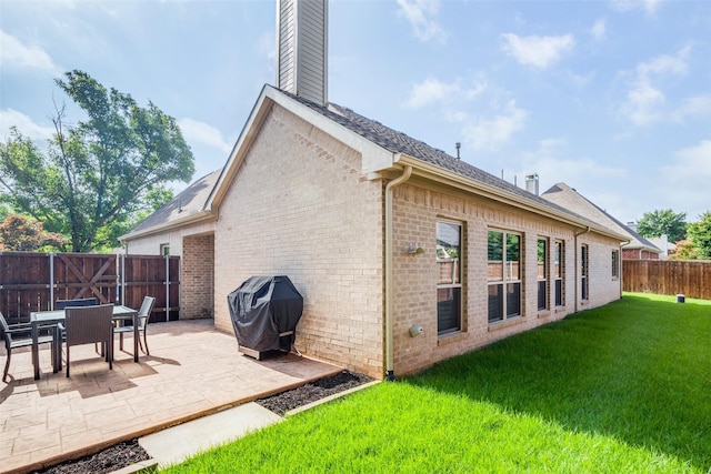 1908 Thompson Ct, Flower Mound, TX 75028 - rear view of house with a chimney, brick siding, a patio, a fenced backyard, and roof with shingles