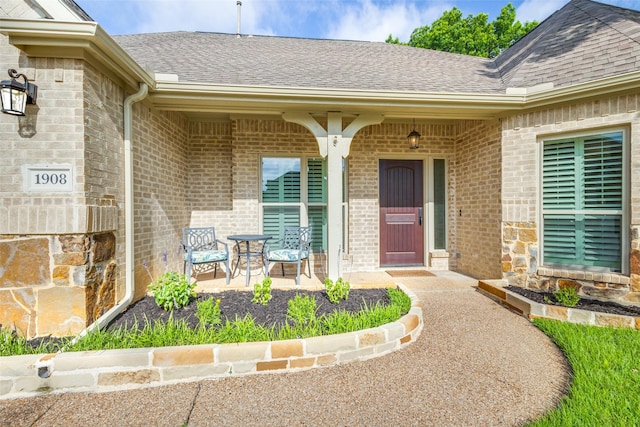 1908 Thompson Ct, Flower Mound, TX 75028 - doorway to property with roof with shingles, brick siding, and a porch