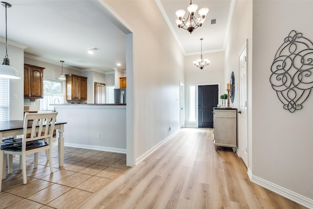 1908 Thompson Ct, Flower Mound, TX 75028 - hall featuring a chandelier, crown molding, and light wood-style flooring